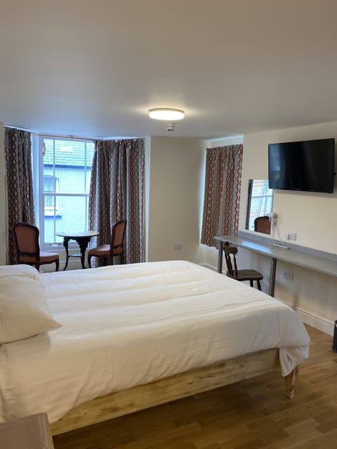 Desk, iron/ironing board, bed sheets