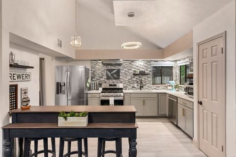 Modern kitchen where good vibes and great meals come together! Perfect for gathering around the spacious island or enjoying the sleek stainless steel appliances. Welcome to your home away from home!
