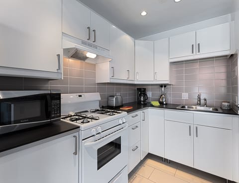 Deluxe Room, 1 King Bed | Private kitchen | Full-size fridge, oven, stovetop, espresso maker