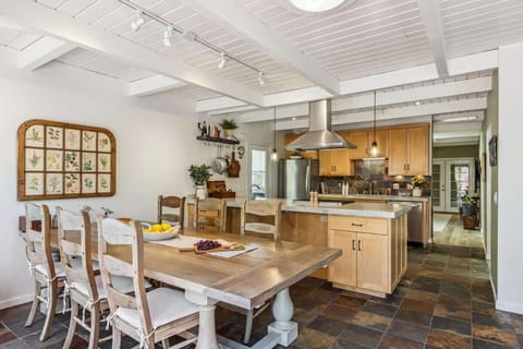Bright and welcoming, this kitchen and dining area offers plenty of space for shared meals. Enjoy warm wood accents, an open layout, and a comfortable place to cook, gather, and relax.