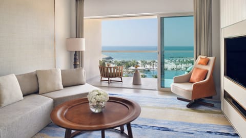 Suite, 1 King Bed, Sea View | Living room | 50-inch flat-screen TV with satellite channels, TV