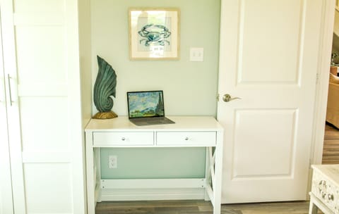 Primary Bed 2 - Computer desk and chair with closet storage.