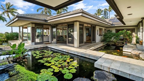 Courtyard with stone pavers, Koi pond, leading into the home