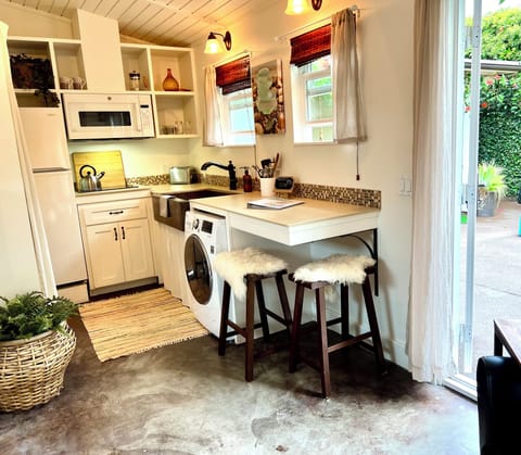 Full kitchen including copper sink, induction & convection cooking options.