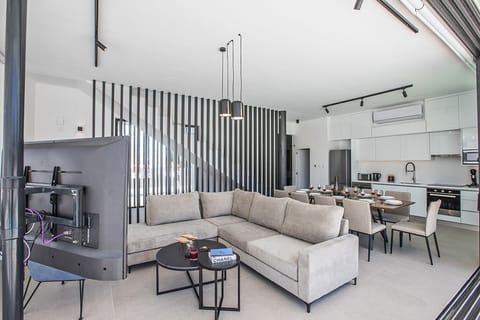 Living room with comfortable corner sofa, coffee table and Smart TV