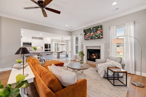 Welcome to The Marigold! Our bright, open living room features a well-lit space, 65-inch Smart TV and cozy seating for our guests.