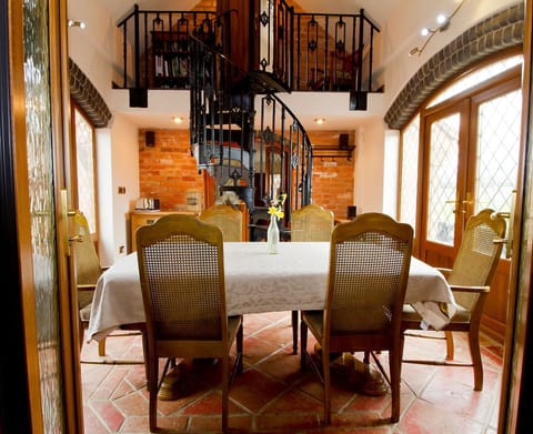 Coach House dining area spiral stair case leading to en-suite bedroom