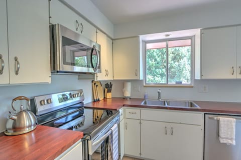 Well equipped kitchen with new appliances and backyard views