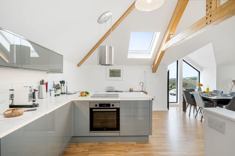 Cedar House, St Agnes. First floor: Fully-equipped kitchen with an electric oven and hob, microwave, dishwasher, fridge/freezer and washing machine