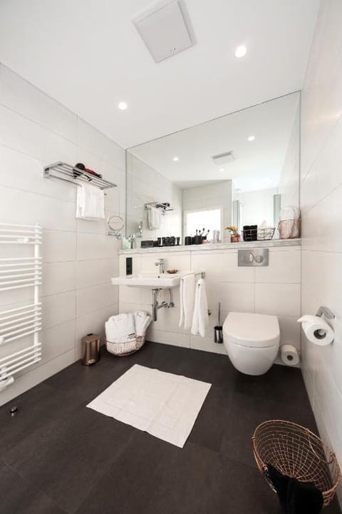 Shower, designer toiletries, hair dryer, slippers