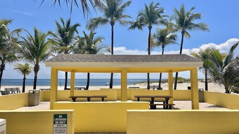 Just a 5 minute walk, enjoy the quiet private beach area with ample beach space, parking, showers, charcoal grills, a covered pavilion and dining tables.