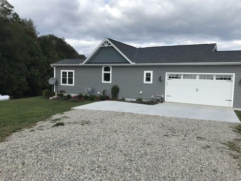 Diagonal lines mark parking spaces on left of garage doors. Do not block garage.