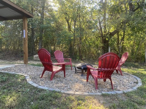 Fire pit area with Adirondack chairs, now featuring a smokeless firepit.