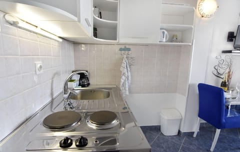 The kitchen with electric oven with two hotplates, refrigerator, coffee machine and mocha.