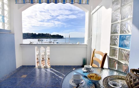 The balcony with sea view furnished with table and chairs