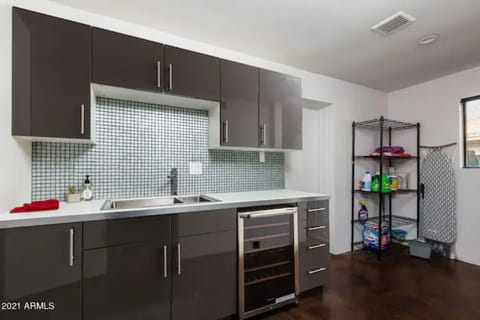 2nd master bedroom's mini kitchen w/wine fridge and sink.
