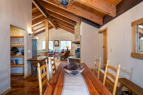 This large dining setup features a table that comfortably seats eight, making it ideal for everything from casual breakfasts to formal dinners