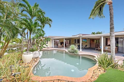 Beautiful pool area overlooking the water with lounge chairs in the pool.