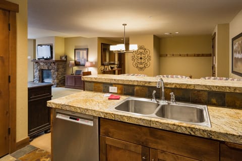 Kitchen and bar area. Fully stocked with cookware and dishware.