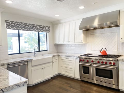Kitchen with Dual Wolf Oven Stove with Griddle.