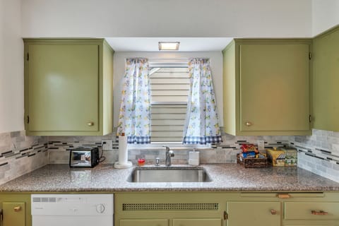 Conveniently laid out kitchen stocked with small appliances, cookware and dishes