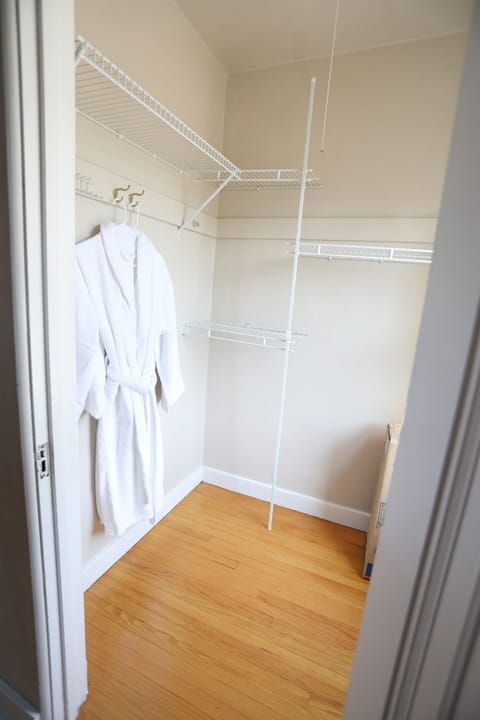 The E Bedroom features two walk-in closets. This walk-in closet holds the robes as well as a Pack N Play..