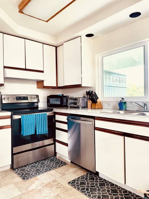 Kitchen fully stocked with cooking essentials and utensils.