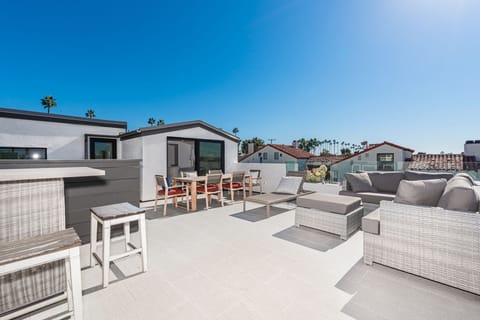 The rooftop deck is expansive and looks out on the idyllic streets of Corona Del Mar and ocean beyond.
