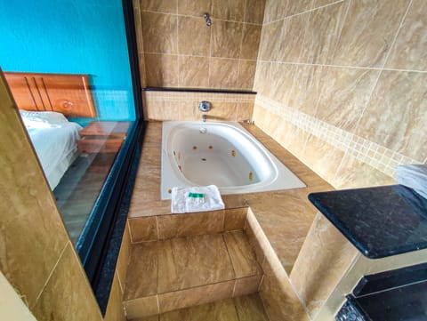 Exclusive Room, 1 King Bed, Non Smoking, Jetted Tub | Bathroom | Bathtub, free toiletries, towels, soap