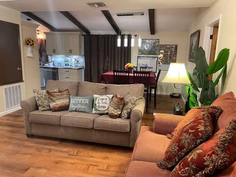 Den, table and kitchen