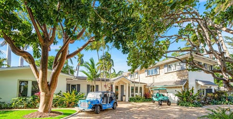 This Spanish Revival ample residence is located in the private Harbor Beach neighborhood.