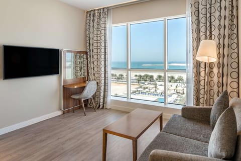 Junior Suite | Living area | 40-inch LED TV with cable channels, TV