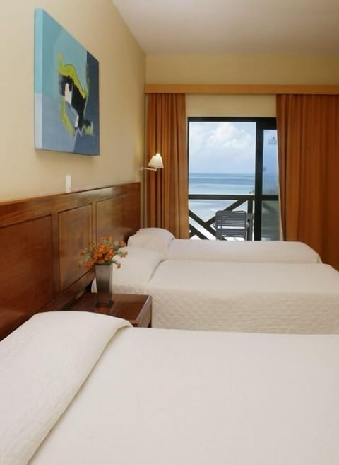 Superior Triple Room, Sea View | Minibar, free cribs/infant beds, bed sheets