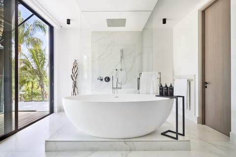 LUX* Grand Beach Pool Villa | Bathroom | Separate tub and shower, rainfall showerhead, eco-friendly toiletries