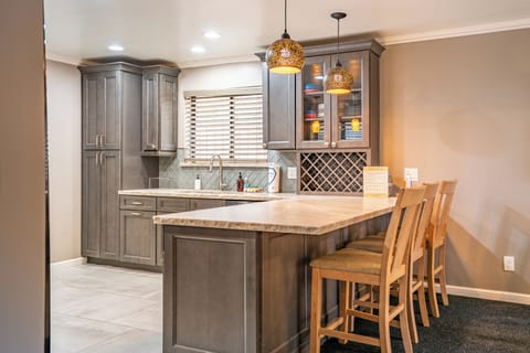 Kitchen's barstool seating with pendant lighting.