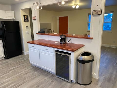 Custom island with mini fridge. The breakfast bar has additional seating. 