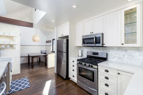 Remodeled kitchen, with custom-built cabinetry, and stainless steel appliances.