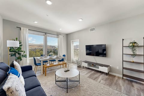 Living room with smart TV, seating, and mountain-view moments.