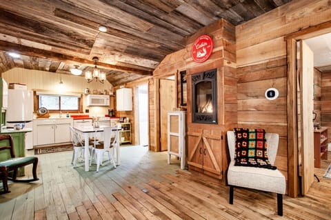 This open-concept space offers a seamless flow between the rustic kitchen and cozy living area, creating the perfect environment for hosting or relaxing at home.