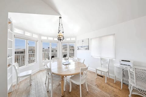 The upstairs dining area is bathed in light and surrounded by beachy accents. Table seats 6-8.
                