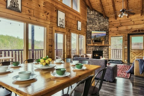 Open space living and dining room with Cathedral ceiling, fireplace and views!