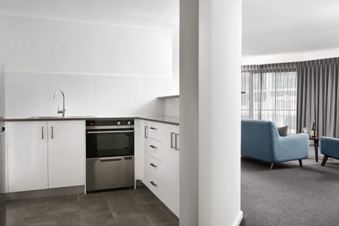 One Bedroom Executive Apartment | Private kitchen | Full-size fridge, microwave, oven, stovetop