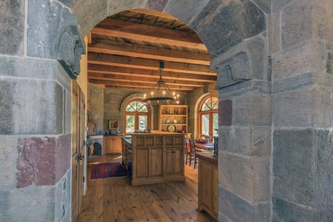 Handcrafted Stone Archway from Living and Dining to Kitchen