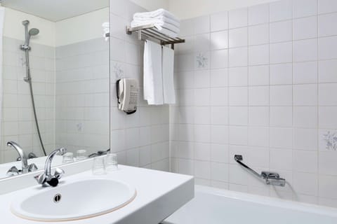 Deep soaking tub, rainfall showerhead, eco-friendly toiletries, towels