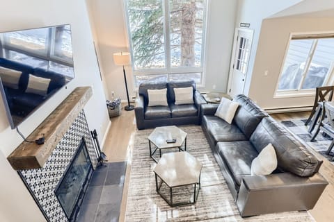 Open living room with wood-burning fireplace