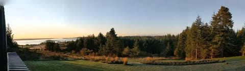 Salish Sea and Olympic Mountain views across the meadow and forest at the Inn