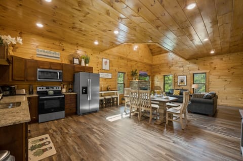 Get ready to fall in love with our open concept living, dining, and kitchen area, the heart of our cabin and the perfect destination for your Smoky Mountains adventure.