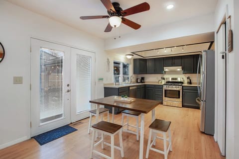 The open concept kitchen features a small bistro table for 4. The double doors open to the large backyard for extra entertaining space.