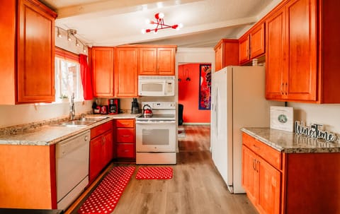 A sleek white stove and dishwasher set the tone for a kitchen that's both functional and stylish.