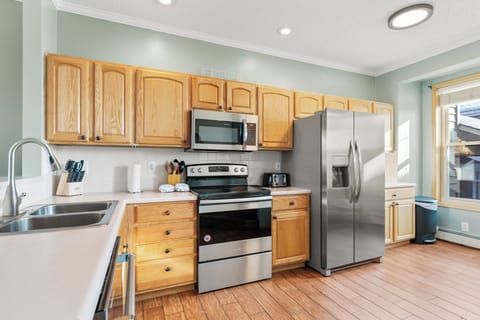 Full size kitchen with hardwood flooring and everything you need to prepare a meal away from home.